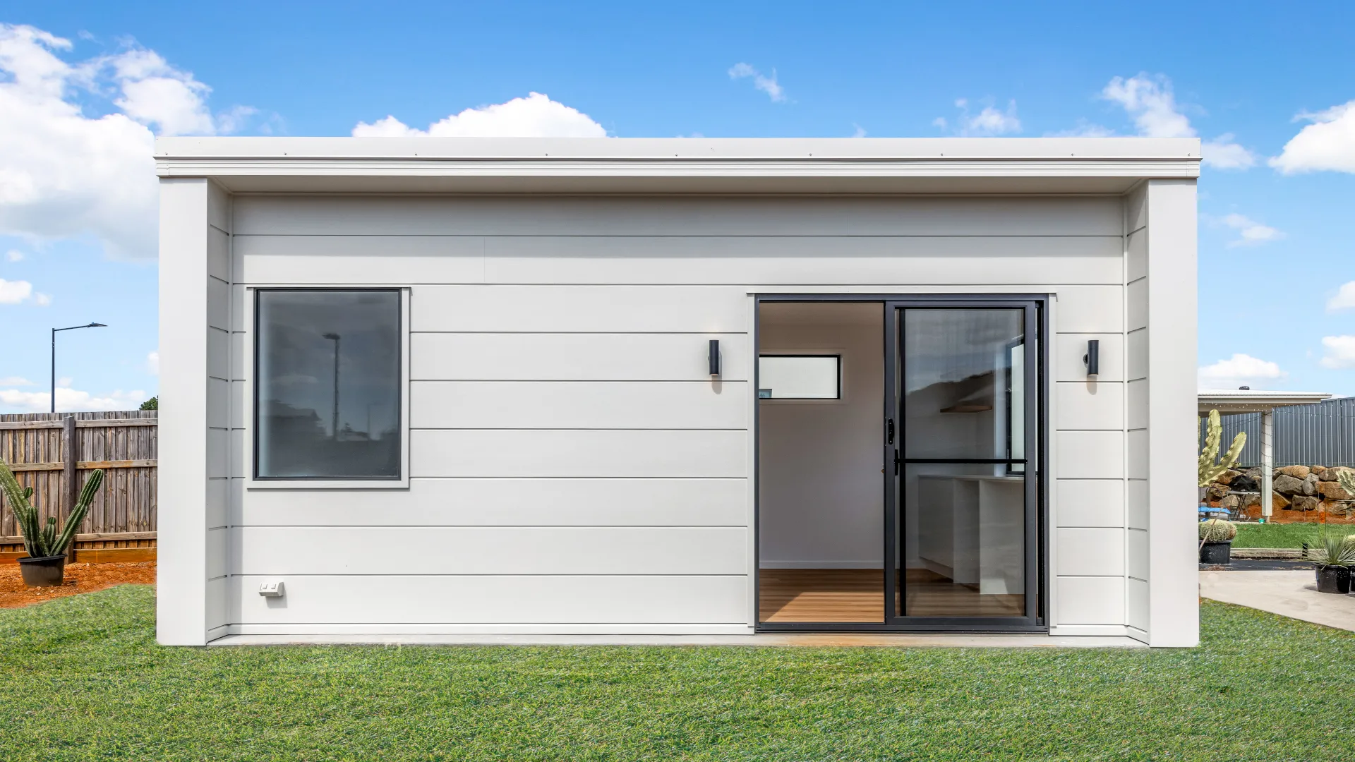 Contemporary Queensland Kit Home Exterior Contemporary kit home with modern cladding, large window and sliding glass door