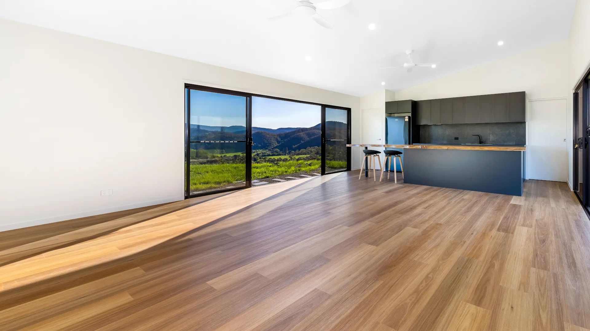Open-plan living and kitchen area with large windows overlooking the Beerwah hinterland