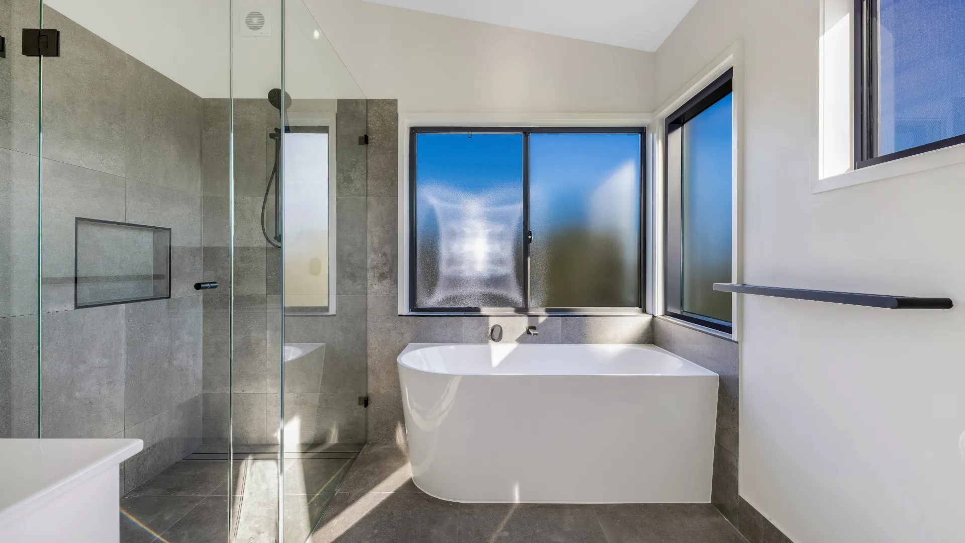 Modern Kit Home Bathroom Modern kit home bathroom with freestanding bath, tiled shower and large windows