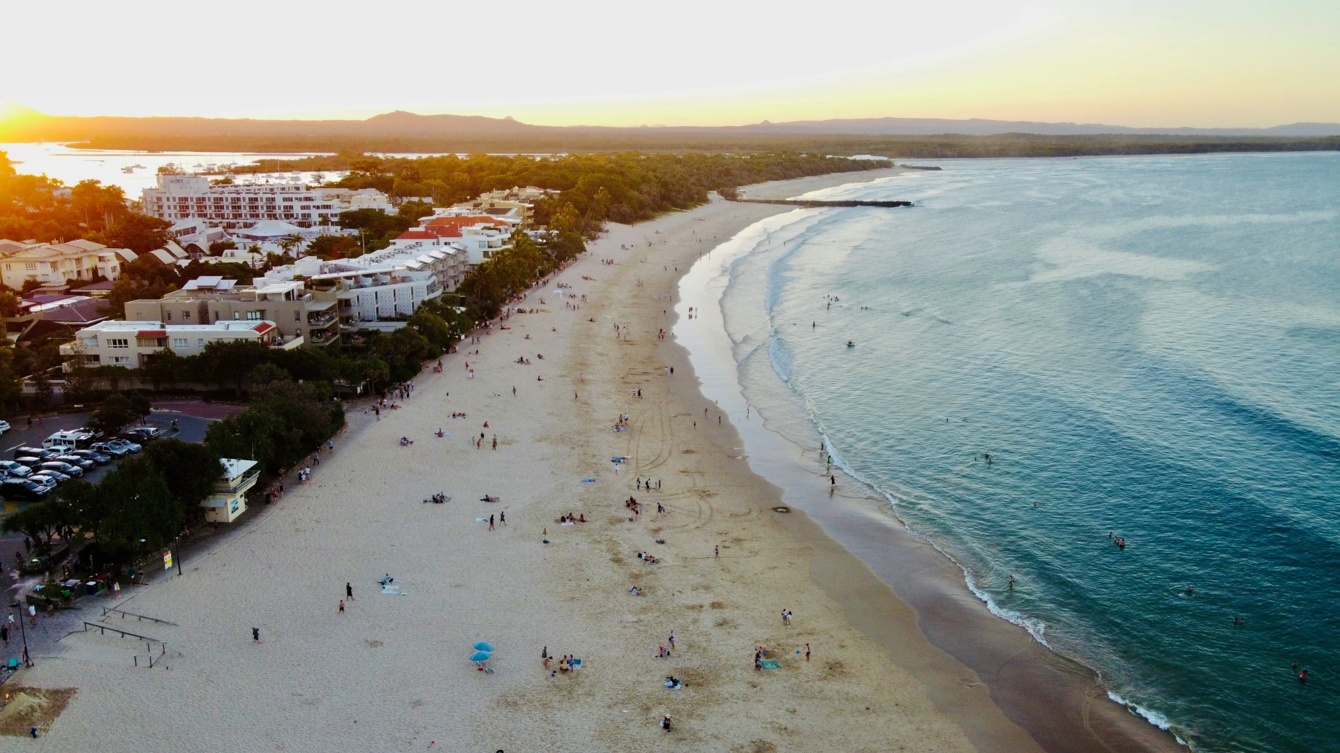 Noosa Main Beach and Coastal Lifestyle Aerial view of Noosa Main Beach at sunset with the Noosa Hinterland in the distance